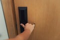 Closeup woman hand is holding door knob to opening a door in the hotel., Security system and access safety of electric door., Royalty Free Stock Photo