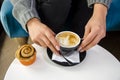 Closeup of woman hand holding espresso coffee