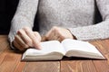 Closeup woman hand holding pocket book to read