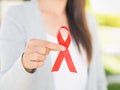 Closeup woman hand holding red ribbon HIV Royalty Free Stock Photo