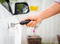 Closeup woman hand holding the remote control car alarm systems. Royalty Free Stock Photo