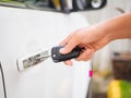 Closeup woman hand holding the remote control car alarm systems. Royalty Free Stock Photo