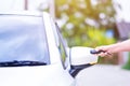 Closeup woman hand holding the remote control car alarm systems Royalty Free Stock Photo