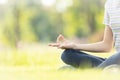 Closeup of woman hand meditating in yoga pose or lotus position on green grass,child girl practicing yoga meditation in nature Royalty Free Stock Photo