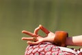 Closeup of woman hand in mudra gesture practice yoga meditation outdoor by the lake summer day