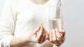 Closeup woman hand with pills medicine tablets, and glass of water. Health care, medical supplements concept. Sport, Vitamin And Royalty Free Stock Photo