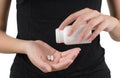 Closeup woman hand pouring white pills into her hand. Royalty Free Stock Photo