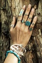 Closeup of woman hand on tree surface with lot of boho style je Royalty Free Stock Photo