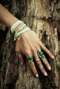 Closeup of woman hand on tree surface with lot of boho style je Royalty Free Stock Photo