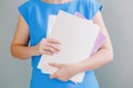 Closeup of woman hands arms holding work papers documents. Work from home or office. Secretary assistant on workplace. Student