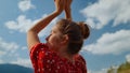 Closeup woman hands cloudy sky. Back view carefree girl raising arms on nature.