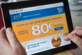 Closeup of woman hands on the credit Lyonnais french bank home page of web site on tablet