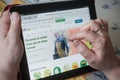 closeup of woman hands on the Ebay home page of web site on tablet