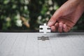 Closeup of woman hands fulfill the last piece of jigsaw puzzle t Royalty Free Stock Photo