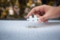 Closeup of woman hands fulfill the last piece of jigsaw puzzle t Royalty Free Stock Photo