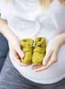 Closeup woman hands holding baby booties Royalty Free Stock Photo