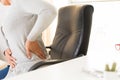 Closeup woman with hands holding her back pain. Office syndrome Royalty Free Stock Photo