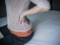 Closeup woman with hands holding her waist back in pain. Royalty Free Stock Photo