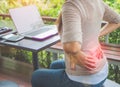 Closeup woman with hands holding her waist back in pain. Royalty Free Stock Photo