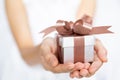 Closeup of woman hands holding a small gift box for special even Royalty Free Stock Photo