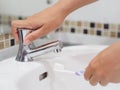 Closeup woman hands is holding toothbrush with toothpaste in sink bathroom Royalty Free Stock Photo