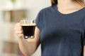 Closeup of a woman hands holding a transparent coffee cup