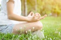 Closeup of woman hands meditating in yoga pose or lotus position on green grass,asian child girl practicing yoga meditation in Royalty Free Stock Photo