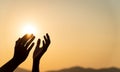 Closeup woman hands praying for blessing from god during sunset background. Hope and freedom concept Royalty Free Stock Photo