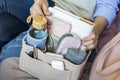 Closeup woman hands putting personal accessories into felt organizer. Concept storage organization Royalty Free Stock Photo