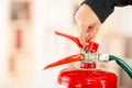 Closeup woman hands with red nailpolish showing how to operate fire extinguisher Royalty Free Stock Photo