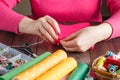 Closeup of woman hands sewing pink hamdmade toy