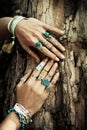 Closeup of woman hands on tree surface with lot of boho style j