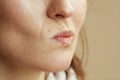 Closeup on woman isolated on beige background