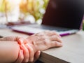 Closeup woman holding her painful hand from using computer.