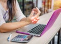 Closeup woman holding her painful hand from using computer