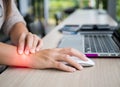 Closeup woman holding her wrist pain from using computer. Royalty Free Stock Photo