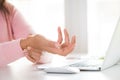 Closeup woman holding her wrist pain from using computer Royalty Free Stock Photo