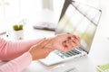 Closeup woman holding her wrist pain from using computer Royalty Free Stock Photo