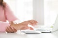 Closeup woman holding her wrist pain from using computer. Royalty Free Stock Photo