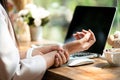 Closeup woman holding her wrist pain from using computer. Office syndrome hand pain by occupational disease Royalty Free Stock Photo