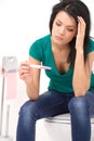 Closeup on woman holding pregnancy test with two stripes.