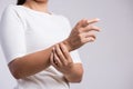 Closeup woman holds her wrist hand injury, feeling pain. Health care and medical conept Royalty Free Stock Photo