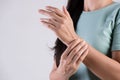 Closeup woman holds her wrist hand injury, feeling pain. Health care and medical conept Royalty Free Stock Photo