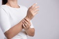 Closeup woman holds her wrist hand injury, feeling pain. Health care and medical conept Royalty Free Stock Photo