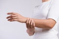 Closeup woman holds her wrist hand injury, feeling pain. Health care and medical conept Royalty Free Stock Photo