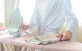 Closeup of woman ironing clothes on ironing board Royalty Free Stock Photo