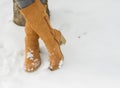 Closeup on woman legs in winter boots on snow Royalty Free Stock Photo