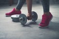 Closeup on woman lifting dumbbell from the floor Royalty Free Stock Photo