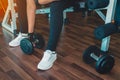 Closeup on woman lifting dumbbell from the floor Royalty Free Stock Photo
