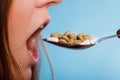 Closeup of woman mouth eating painkiller pills.